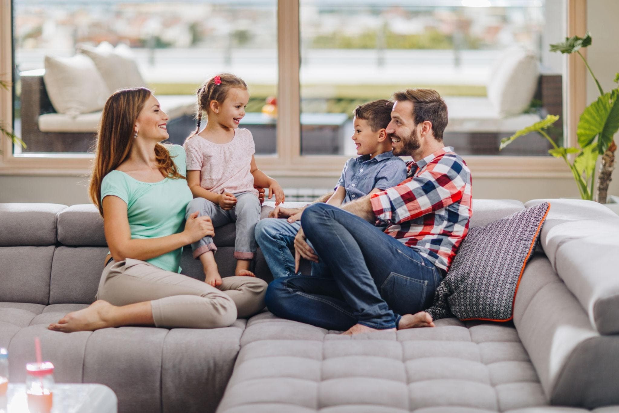 Every Parent and Child Relationship Is Different, Father and Whole family sitting around a table and talking together.
