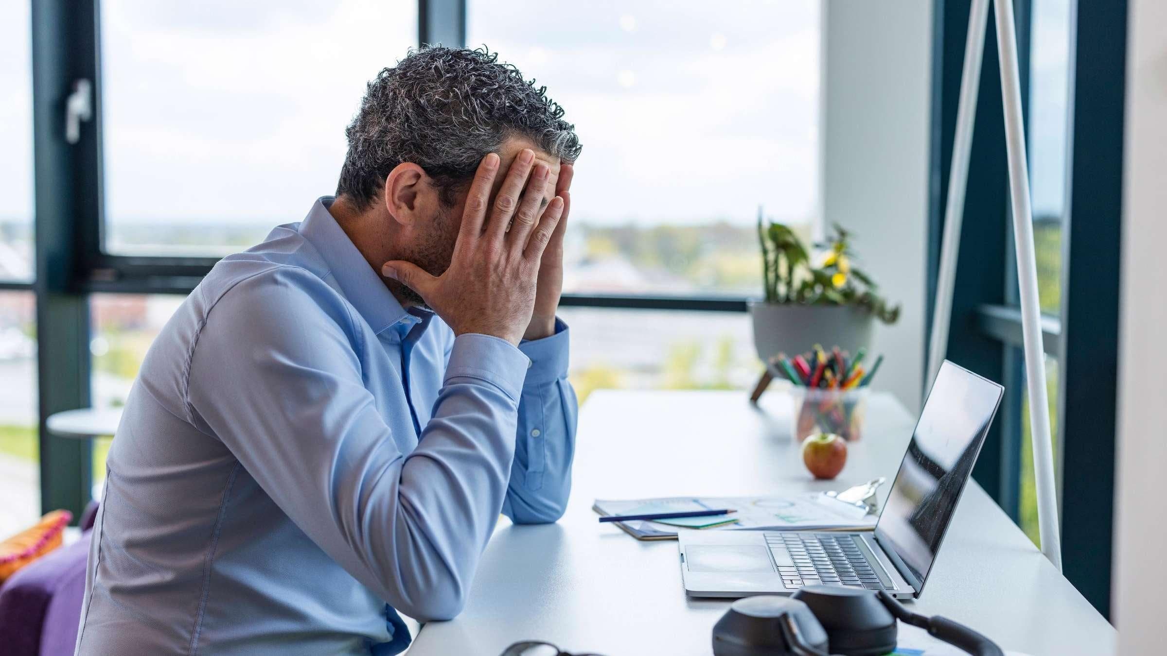 How CBT Can Help You cognitive behavioral therapy counseling Young professional experiencing visible but subtle stress while sitting at a desk, followed by a calming counseling environment.