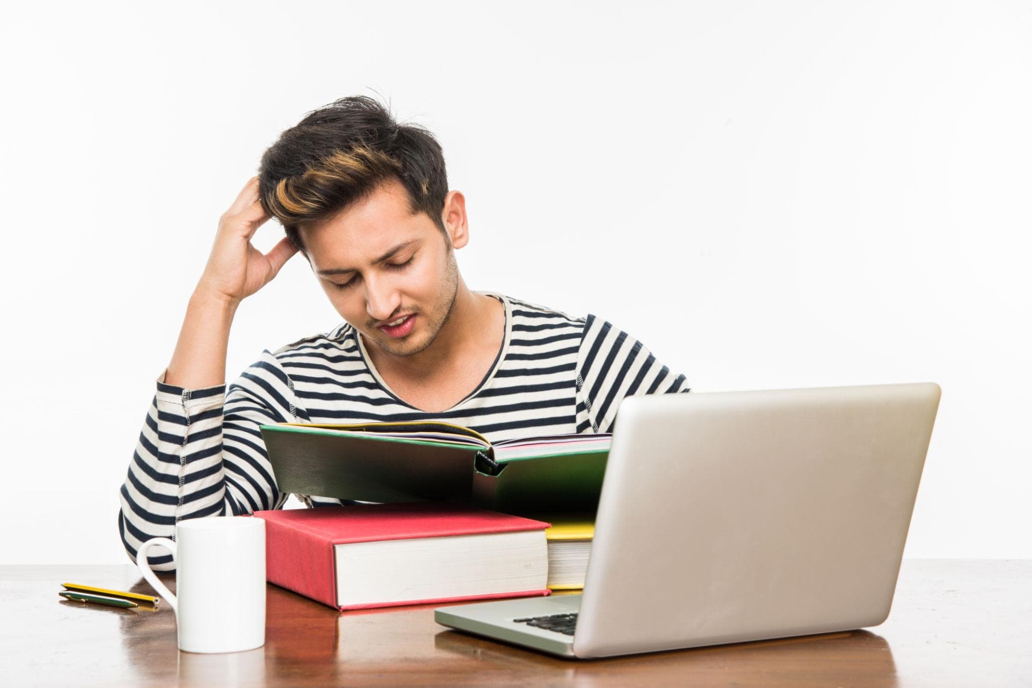 Career Consultancy for Students  Student sitting at a desk with books and laptop, looking overwhelmed by studies. career consultancy for students