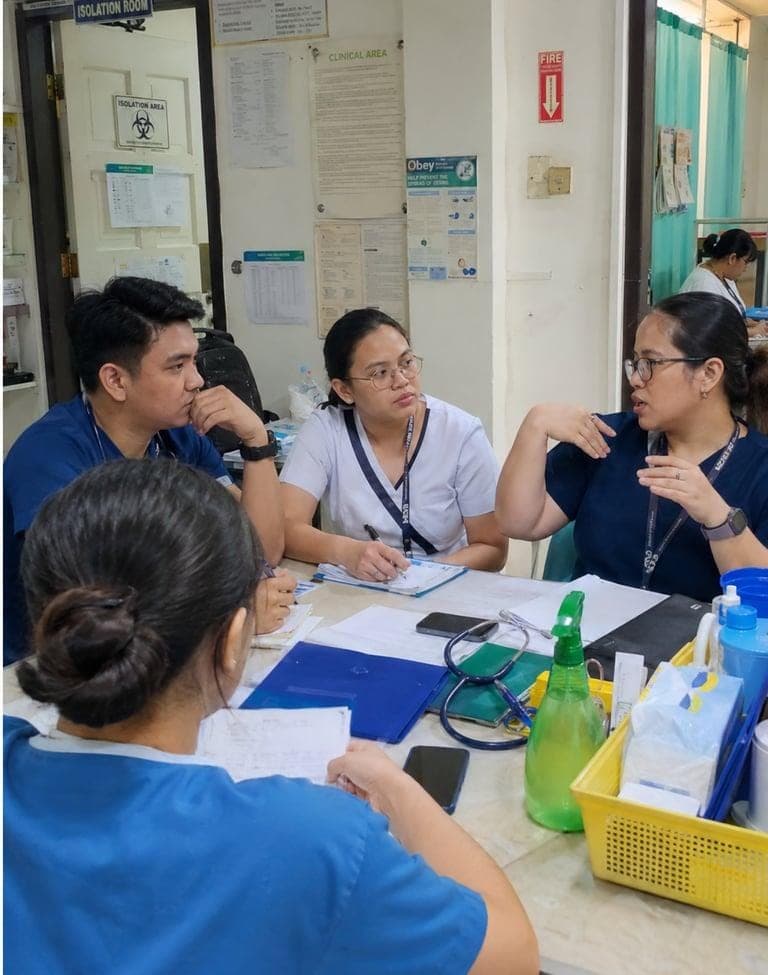 counselling for doctors and Areas of Support for Nursing Professionals Two healthcare professionals having a calm discussion with a senior team member or counselor facilitating communication.