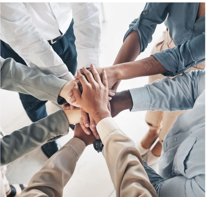 A team joining hands together in a circle with Corporate Counselling Services & wellness Program